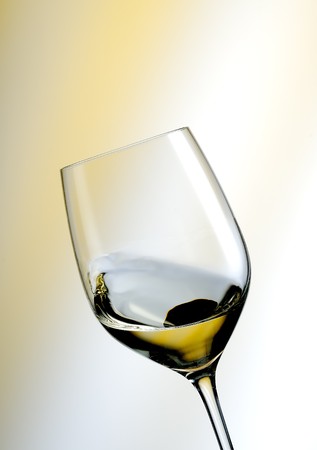 A Glass of white wine in an yellow ambianceの写真素材