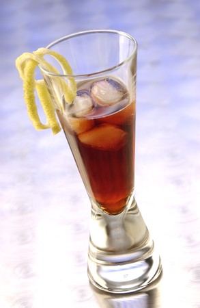 Appetizer Bitter Negroni with ice cubes and slices of lemon in a long drink glass.の写真素材