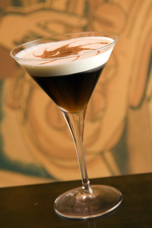 white russian cocktail with a cream in a martini glassの写真素材