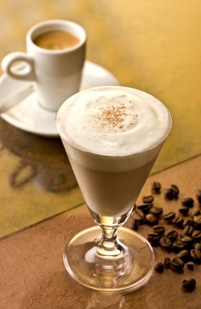 Brandy Alexander cocktail with coffee beans and a cup in the backgroundの写真素材