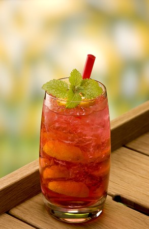 brazilien crush cocktail with a red straw and mintの写真素材