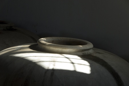 Clay container with hole inside a warehouse.の写真素材