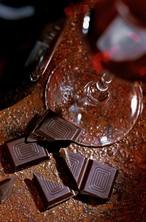 glass of red wine with chocolateの写真素材