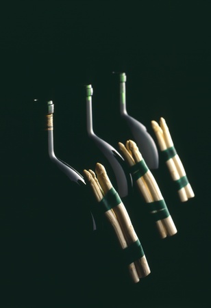 bottle of wine with asparagus and black bacgroundの写真素材