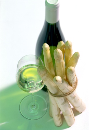 glass and bottle of white wine with asparagusの写真素材