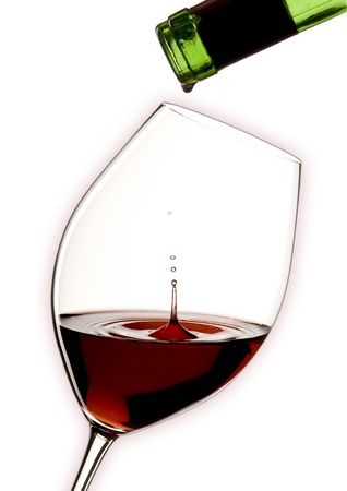 glass of red wine with a green bottle and white backgroundの写真素材