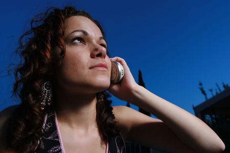 Young woman calling on a cell phone at nightの写真素材
