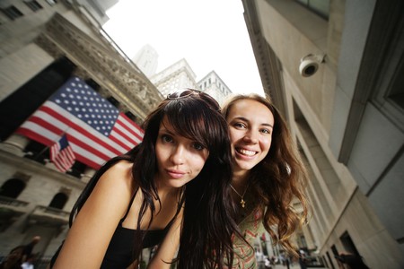Two young women near New York Stock Exchange. WIde angle portrait.のeditorial素材