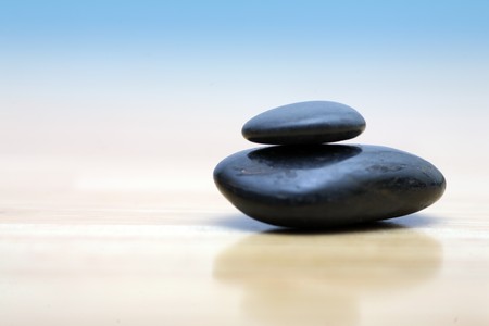 Zen stones on wooden surface. Shallow DOF.の写真素材