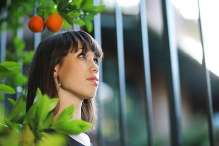 Beautiful girl in orange tree garden. Shallow DOF.の写真素材