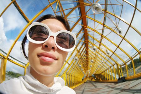 Funny wide angle portrait of a young woman in sunglassesの写真素材