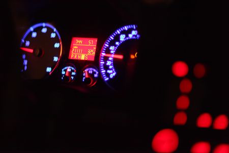 Car dashboard illuminated in the darkの写真素材