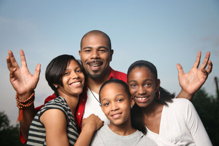 Happy African American family. Father with three teenage daughters together having a good time.の写真素材