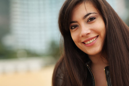 Portrait of happy young woman smiling, looking at camera. Close-up, shallow DOF.
