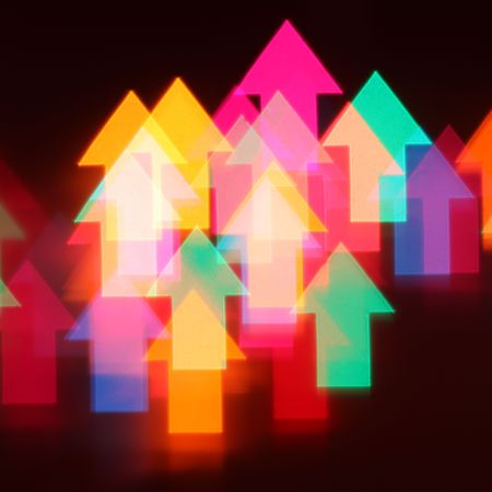 Abstract background of colorful glowing arrowsの写真素材