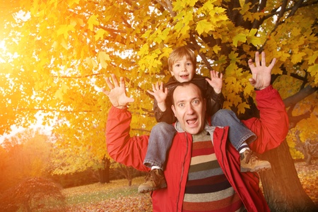 Father and son in autumn parkの写真素材