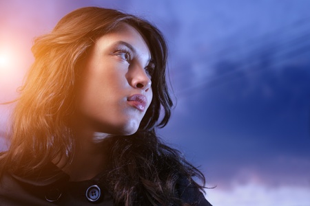 Beautiful asian woman looking up at twilightの写真素材