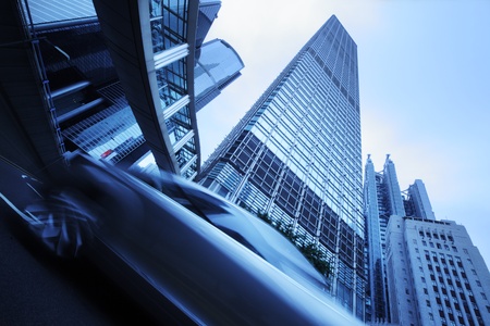 Modern city architecture. Wide angle view from below on skyscrapers, bridge and moving cars.の写真素材