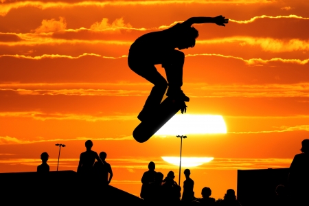 Jumping skateboarder silhouetteの写真素材