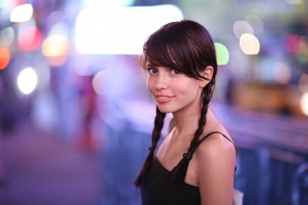 Portrait of beautiful petite woman in night city. Shallow DOF.の写真素材