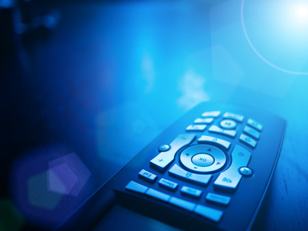 Media tv remote control on blue background, closeup. Copyspace.