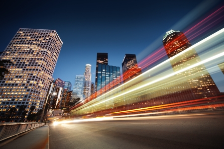 Los Angeles at night. Long exposure shot of blurred bus speeding through night street.