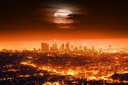 Dramatic full moon over Los Angeles skyline at night.の写真素材