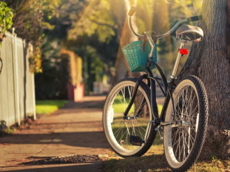 Retro styled bicycle on sunny street. Shallow DOF, focus on rear wheel.の写真素材