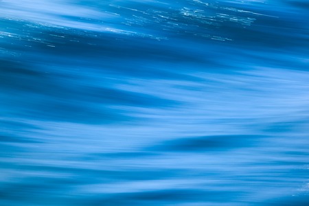 Water waves blurred motion abstract backgroundの写真素材