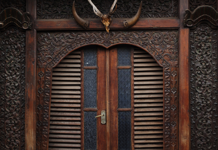 Wood Carving in front of house with door viewの写真素材
