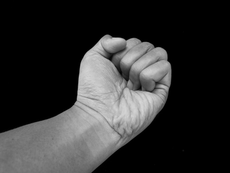Gestures Hand Punching, Agression, Isolated on Black Backgroundの写真素材