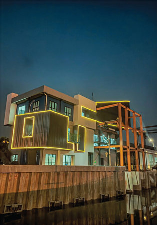Night view of a modern building with colorful lights in the foreground.の写真素材