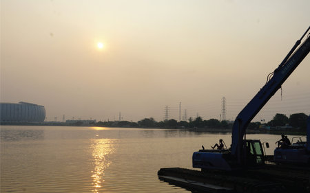 Truck on the river in the evening. The sun goes down.の写真素材
