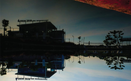 Reflection of a hotel on the water at sunset