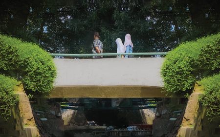 Unidentified people sitting on the bridge