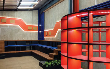 Interior of a modern office building with red and blue walls.の写真素材