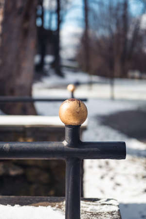 Detail of an old, steel, handrail in a park covered with snow during sunny day, Mikolow, Polandの写真素材