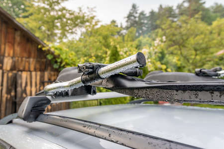 Roof bike rack on a silver car, coutryside landscape in backgroundの写真素材