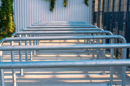 Metal railings in front of gates of Silesian Stadium in ChorzÃ³w, Poland. Row of steel rails. Entrance to the sport arena.の写真素材