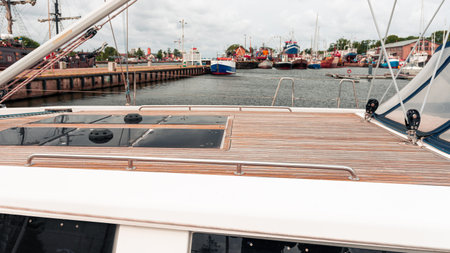 Wooden deck of a large yacht moored in the port of DarÅ‚owo on the Baltic Sea