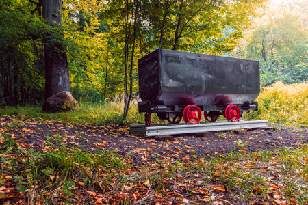 A restored mine cart displayed in the park in Katowice as a symbol of the mining tradition. Black...