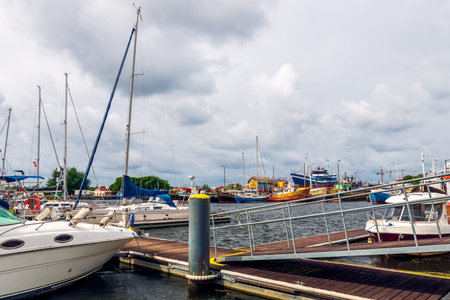 Harbor on Baltic Sea in DarÅ‚Ã³wko, Poland. Sailboats and fishing cutters floating on a water...