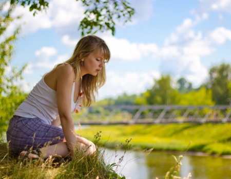 Beautiful girl looking for a river  Sunny Dayの写真素材