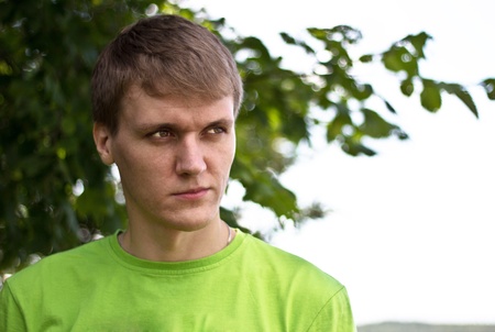 A young man spends time outdoors on a sunny dayの写真素材