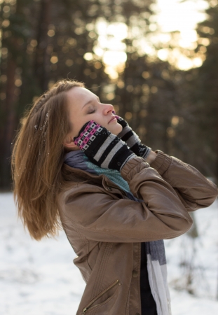 Pretty girl walking in the woods in the early winterの写真素材