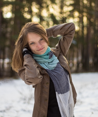 Pretty girl walking in the woods in the early winterの写真素材