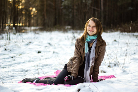 Pretty girl walking in the woods in the early winter