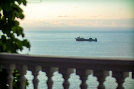 A boat is gently floating on the surface of a calm body of waterの写真素材