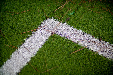 A distinct white line is clearly painted on a soccer field areaの写真素材