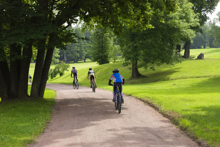 Some bicyclists on the sandy track in park
